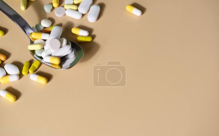 Photo for Colourful pills in a spoon. Well-beign or medicine concept - Royalty Free Image