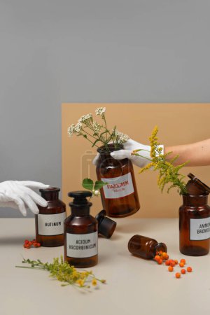 Photo for Medicine or well-being concept.Medical jars, pills and flowers on a table - Royalty Free Image