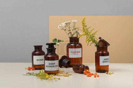 Photo for Medicine or well-being concept.Medical jars, pills and flowers on a table - Royalty Free Image