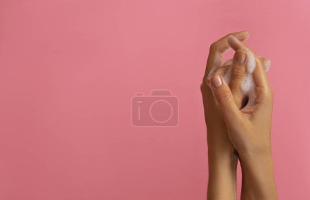 Photo for Female hands washing with soap on pink background - Royalty Free Image