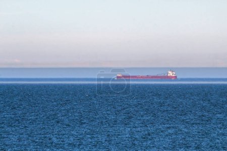 Photo for A canada steamship lines laker crosses the canadian side of lake superior as seen from the keewenaw peninsula in michigan - Royalty Free Image