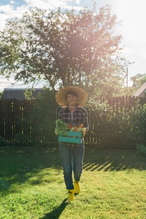 farmer carrying box of picked vegetables tote bag #640438438