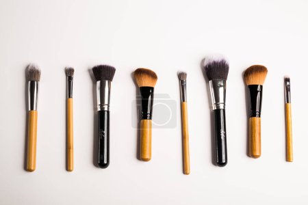 Assorted make up brushes, top view. White background with copy space puzzle 645356010