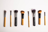 Assorted make up brushes, top view. White background with copy space Poster #645356010
