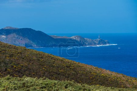 View of a lighthouse on top of headland on the Atlantic Ocean coast. Punta Nariga, Costa Da Morte, Galicia, Spain