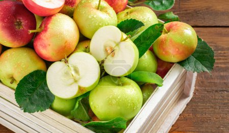 Photo for Harvest fresh red and green apples in wooden box on wooden table close up top view with copy space - Royalty Free Image