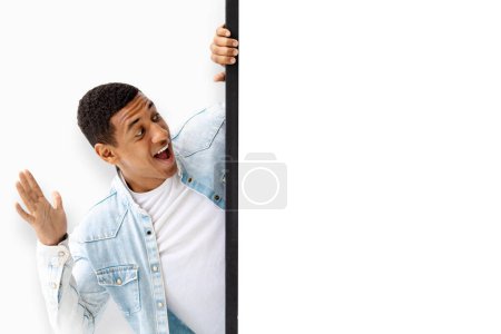 Photo for Surprised happy young African American man guy in casual shirt posing with a surprised expression isolated on white wall background. Sale concept - Royalty Free Image