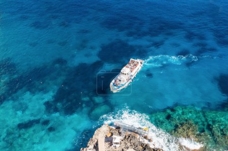 Photo for Aerial view beautiful seascape with stone dock and ship with tourists top view. Sea coast with blue, turquoise clear water on sunny day, aerial drone shot - Royalty Free Image