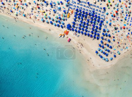 Photo for Top view of beautiful sandy popular beach La Pelosa with turquoise sea water and colorful umbrellas, Islands of Sardinia in Italy, aerial drone shot - Royalty Free Image