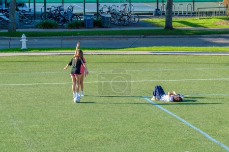 Photo for NEW ORLEANS, LA, USA - DECEMBER 16, 2022: Three teenager girls having fun on a soccer field on Tulane University campus - Royalty Free Image