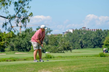 Téléchargez les photos : NOUVELLE-ORLÉANS, LA, ÉTATS-UNIS - 28 MAI 2023 : Gros plan d'un golfeur qui termine son putt sur le green du Audubon Park Golf Club - en image libre de droit