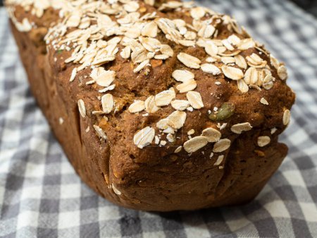 Photo for Healthy newly baked oat bread on white and blue and grey linen cloth - Royalty Free Image