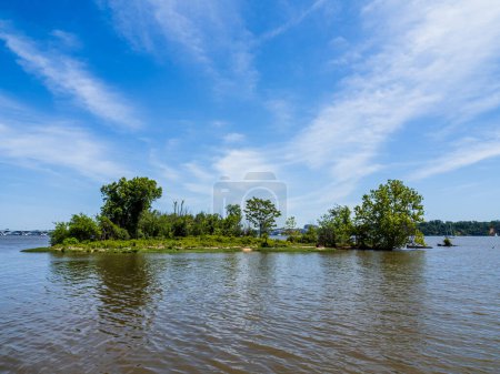 Photo for A beautiful sky above an island located in the Potomac River in Virginia, USA, seen from Dyke Marsh. - Royalty Free Image