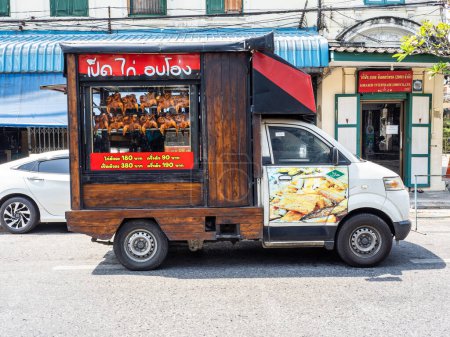 Photo for Bangkok, Thailand - 2/18/2023: A street-side food truck in Bangkok, Thailand, showcases wooden accents and offers delicious roasted chicken. - Royalty Free Image