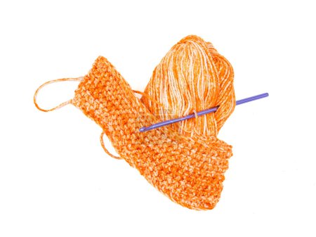 Photo for On a white backdrop, an isolated purple crochet hook accompanies pumpkin colored yarn. - Royalty Free Image