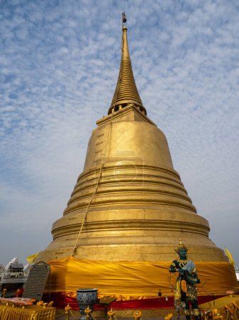 Photo for Stretching into the sky, the temple's pinnacle, a radiant golden spire atop Wat Saket, the Golden Mount in Bangkok, Thailand. - Royalty Free Image