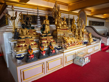 Photo for Arranged in a staggered formation on a base at Bangkok's Wat Saket, the Golden Mount, are Buddha statues in black and gold. - Royalty Free Image