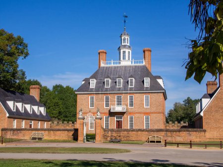 Photo for In historic colonial Williamsburg, Virginia, the Governor's Palace with its front lawn and clear blue sky above stands as a magnificent sight. - Royalty Free Image