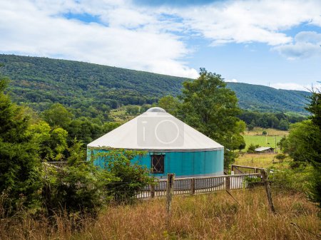 Photo for A yurt, an old type of tent-like house, in Mathias, West Virginia, with the hills and forest as backdrop. - Royalty Free Image