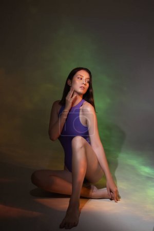 Photo for Portrait of young woman with neon light reflection on body over multicolored background. Concept of art, modern style, cyberpunk, futurism and creativity. Creative portrait of young girl - Royalty Free Image