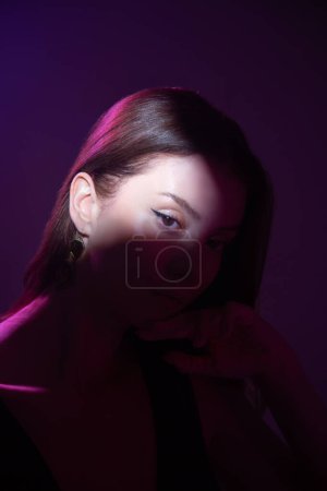 Photo for Fashionable beauty portrait. silhouette on black background. woman with a spot of light on her face. elegant beauty concept - stylish lady with beautiful makeup in a spot of light - Royalty Free Image