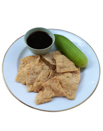 Photo for ISOLATED Crispy mpek mpek fish skin deep fried served with cucumber and sour spicy vinegar sauce Indonesian traditional snack from Medan Sumatera - Royalty Free Image