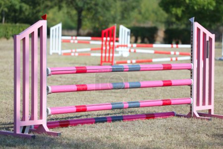 Photo for Show jumping poles obstacles, barriers, waiting for riders on show jumping training. Horse obstacle course outdoors summertime - Royalty Free Image