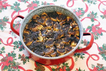 Photo for Freshly baked makos guba in a hot pan.Authentic homemade specialty sweetness with poppy seeds and raisins dish at Christmas Eve in Hungary - Royalty Free Image
