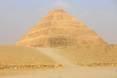 Panoramic view of Stepped Pyramid of Djoser at Saqqara Egypt on a foggy morning under clouds
