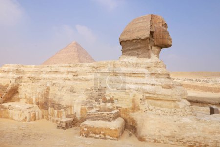 The sphinx with the great pyramid peeking out behind her shoulder. Giza Cairo Egypt Africa