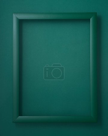 Photo for Green wooden picture frame on green background - Royalty Free Image