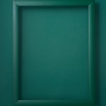 Green wooden picture frame on green background