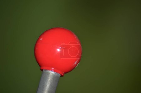 Foto de Detalle de una palanca de la máquina con una punta roja redondeada sobre un fondo borroso - Imagen libre de derechos