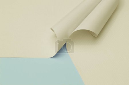 Foto de Dos rollos de tela flexible blanca sobre un fondo azul claro. muestras de tela de color pastel con textura fibrosa. material de banner, industria de impresión digital - Imagen libre de derechos