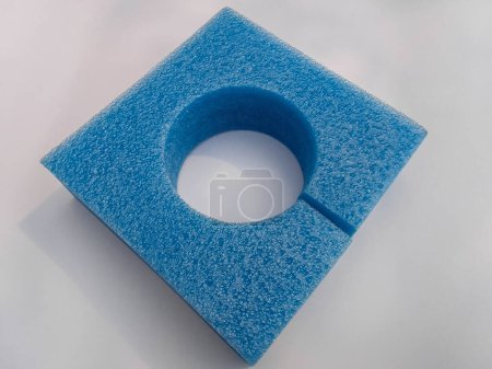 Photo for Rectangular hollow synthetic foam sponge on a white background. elastic blue material for cushioning for packing sensitive products or items - Royalty Free Image