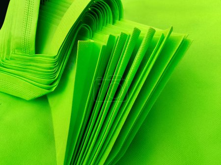 Photo for Pile of green porous tote bags. non-woven fabric material. polypropyline bag - Royalty Free Image