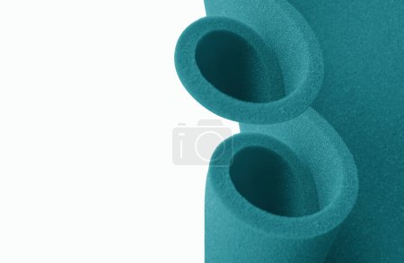 Photo for Two rolls of turquoise sponge foam with copy space. creative foam with simple composition isolated on white - Royalty Free Image
