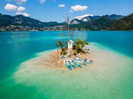 Photo for Relaxing on Ochsenkreuz Island after Paddling on Lake Wolfgangsee The Perfect Retreat for SUP Board Enthusiasts in Austria - Royalty Free Image