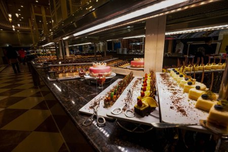 Photo for Variety of sweets including cakes, eclairs and Turkish sweets, arranged beautifully on a table in a luxury all-inclusive hotel. perfect for use in food, travel and luxury related designs - Royalty Free Image