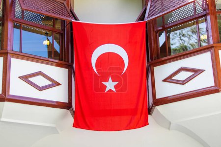 Photo for Large Turkish flag displayed prominently on the wall of a house, representing national pride and identity. - Royalty Free Image