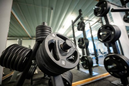Photo for Sports equipment in gym. Barbells of different weight on rack. - Royalty Free Image
