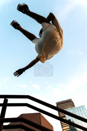 Photo for Unrecognized cool man practicing parkour tricks in the city and having fun. - Royalty Free Image
