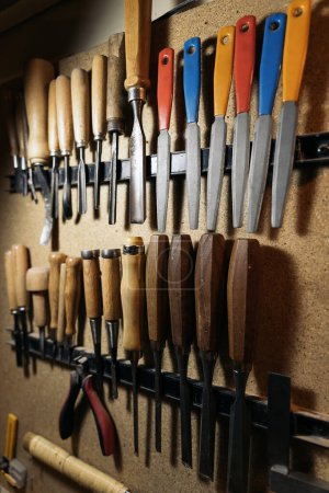 Photo for Close up of variety of tools from a musical workshop used to create a musical instrument. - Royalty Free Image