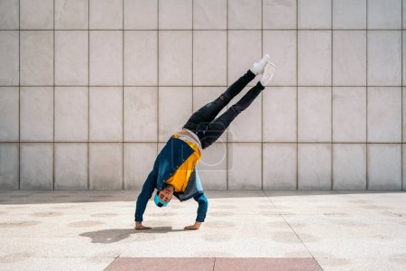 Photo for Cool young man doing break dance moves in the city and having fun. - Royalty Free Image