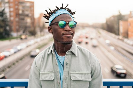 Foto de Hombre africano guapo y seguro de sí mismo con gafas de sol y mirando al frente. - Imagen libre de derechos