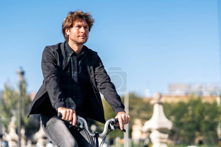 Téléchargez les photos : Stock photo of handsome man using his detachable bike in the street. - en image libre de droit