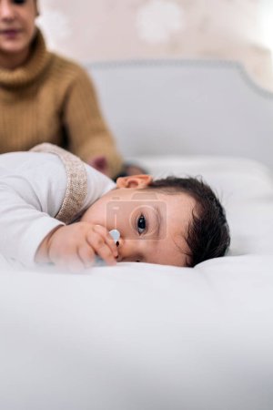 Photo for Stock photo of beautiful baby resting with her mom in the bed. - Royalty Free Image