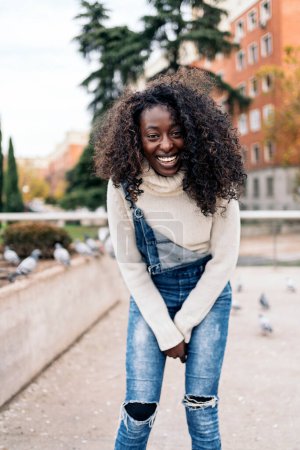 Photo for Stock photo of young black girl smiling and looking at camera in the city. - Royalty Free Image