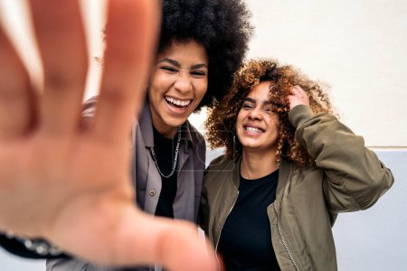 Foto de Stock photo of cool afro girls smiling and looking at camera over white background. - Imagen libre de derechos