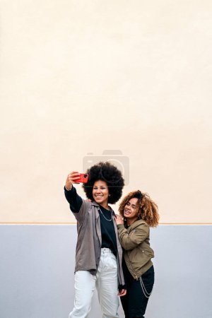 Photo for Stock photo of beautiful african american friends taking picture with phone. - Royalty Free Image
